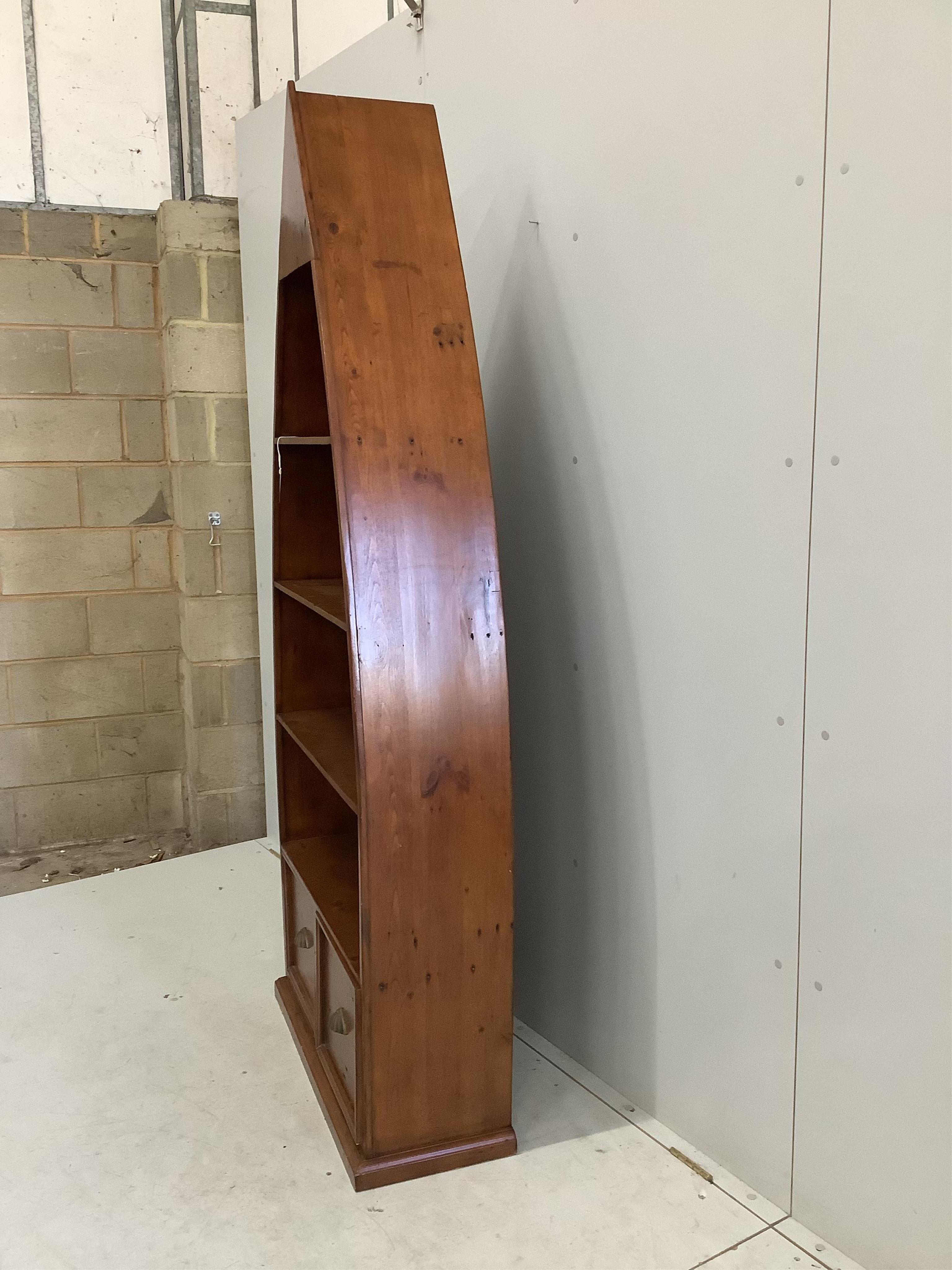 A reproduction Barker and Stonehouse hardwood boat shaped two drawer bookcase, width 83cm, depth 32cm, height 204cm. Condition - fair to good